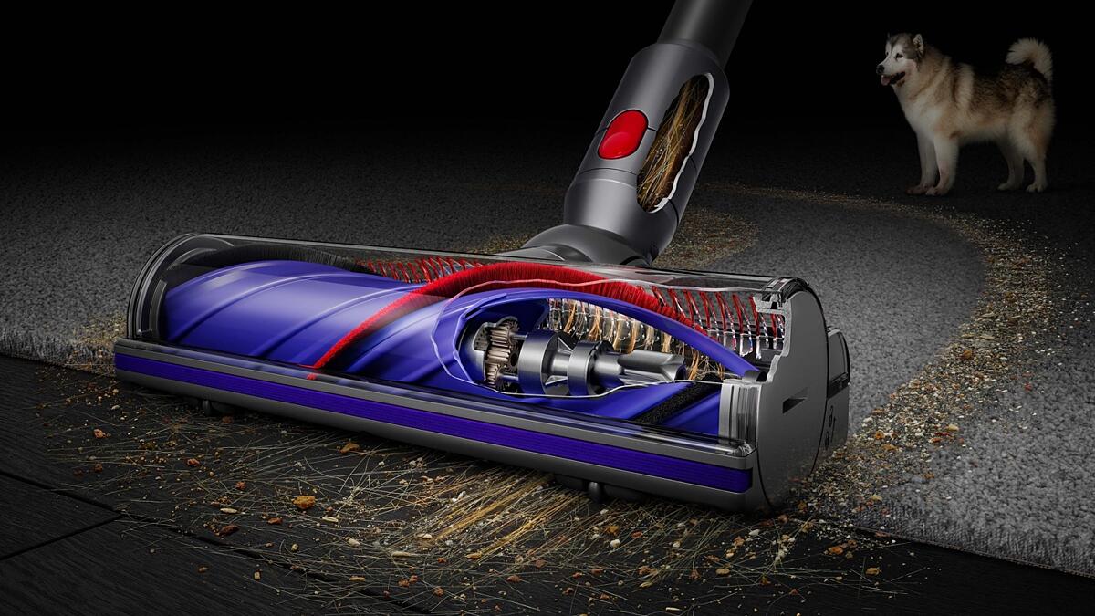 A cutaway showing the Motorbar cleaner head cleaning up hair from carpet and hard flooring.